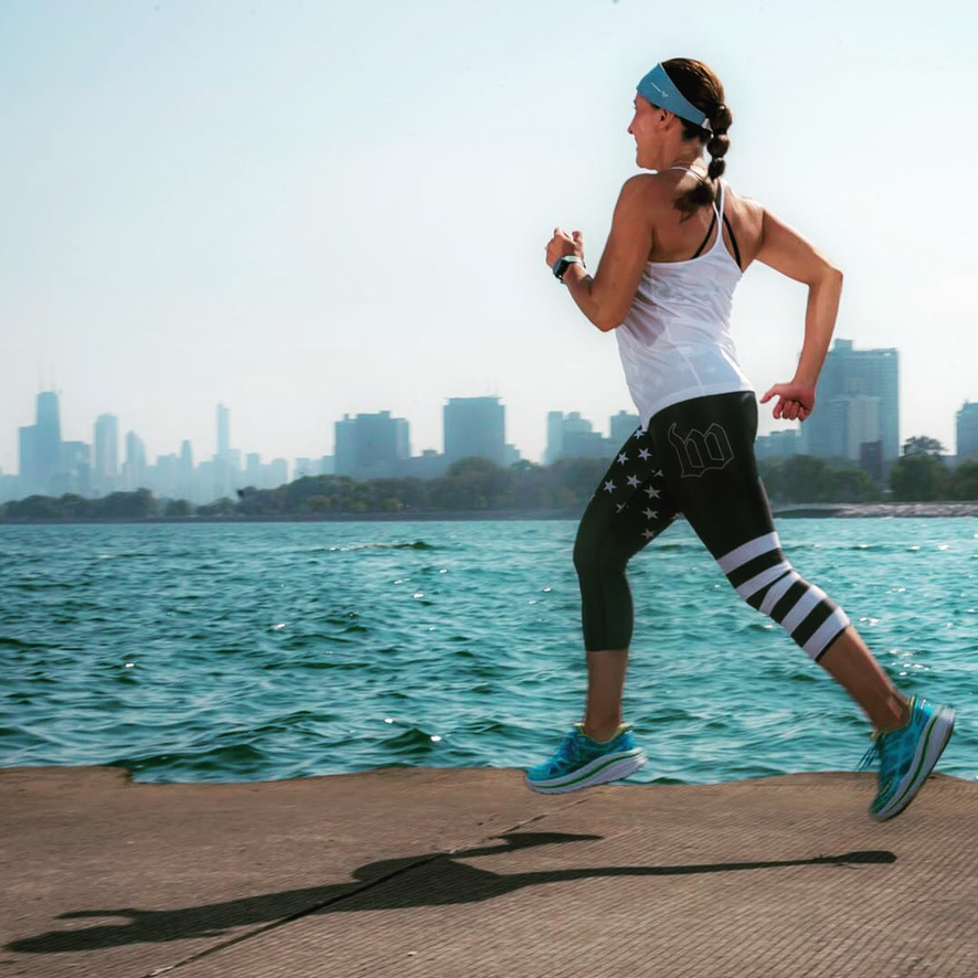 woman running along Chicago lakefront as part of a mindfulness and wellness group focused on stress relief and emotional well being